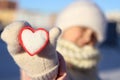 a snow heart with a red border in hands Royalty Free Stock Photo