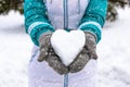 Snow heart in woman's heand. Winter romantic concept