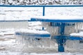 Icicles on blue park bench and table Royalty Free Stock Photo