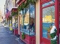 snow, icicles, green garland and red bells on Stockbridge Main Street shops at Christmas Royalty Free Stock Photo