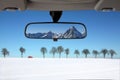 Snow landscape in the car rear mirror Royalty Free Stock Photo