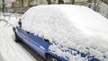 Snow layer on windscreen, window of sedan in city street driveway parking lot spot. car stuck after heavy blizzard Royalty Free Stock Photo