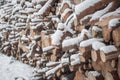 Snow log stack lumber in winter. Woodpile of pine