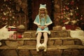 Snow Maiden on doorstep of house decorated in Christmas style Royalty Free Stock Photo