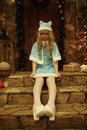 Snow Maiden on doorstep of house decorated in Christmas style Royalty Free Stock Photo