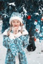 Snow Maiden in the forest. little girl froze over in winter. the child warms his hands. happy new year