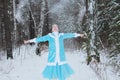 The snow maiden girl walks in the winter forest