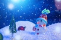 Snow Man with Christmas balls on snow over fir-tree, night sky and moon. Shallow depth of field. Christmas background Royalty Free Stock Photo