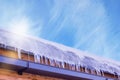 The snow melts from the roof into icicles under the spring sun Royalty Free Stock Photo