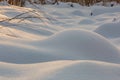 Snow mounds. Erotic snow dunes in the Ukrainian snowy woods evening with soft warm light of sunset Klevan Ukraine. Royalty Free Stock Photo