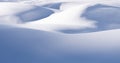 Snow mounds and snowdrifts on sunny winter day. Abstract snowy background Royalty Free Stock Photo