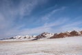 Snow mountain in Mongolia. Scenic landscape with snowy mountain top. Wonderful view from stony snowy mountain to mountain range Royalty Free Stock Photo