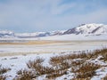 Snow mountain in Mongolia. Scenic landscape with snowy mountain top. Wonderful view from stony snowy mountain to mountain range Royalty Free Stock Photo