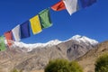 Snow mountain range and tibetan prayer flags in the village ,Leh-Nubra Valley Road Ladakh ,India - September 2014 Royalty Free Stock Photo