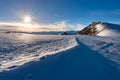 Snow mountains in backlight, bright sunny day winter on the Alps, sun glowing over high snowcapped mountain peaks.