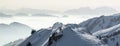 Snow Mountains Panorama in low lying inversion valley fog. Silhouettes of foggy Mountains. Scenic snowy winter landscape Royalty Free Stock Photo