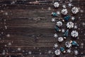 Snow painted pine cones with miniature spruce on rustic dark woo