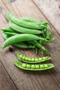 Snow peas on wooden background. Royalty Free Stock Photo