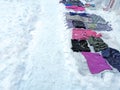 In the snow, people sell things. Flea market in winter. The clothing market right on the ground is winter. On the snow Royalty Free Stock Photo