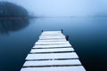 Snow on the pier and foggy lake, Stankow, Poland Royalty Free Stock Photo