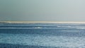 Snow pile, hill. Large snow drift on a blue sky background, outdoor view of ice blocks at frozen finland lake in winter