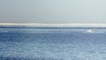 Snow pile, hill. Large snow drift  on a blue sky background,  outdoor view of ice blocks at frozen finland lake in winter Royalty Free Stock Photo