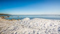 Snow pile, hill. Large snow drift  on a blue sky background,  outdoor view of ice blocks at frozen finland lake in winter Royalty Free Stock Photo