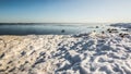 Snow pile, hill. Large snow drift  on a blue sky background,  outdoor view of ice blocks at frozen finland lake in winter Royalty Free Stock Photo