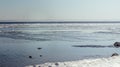 Snow pile, hill. Large snow drift  on a blue sky background,  outdoor view of ice blocks at frozen finland lake in winter Royalty Free Stock Photo