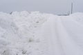 Snow Piles Along Slippery Rural Road