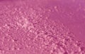 Snow on pink metal car surface with blur effect. Royalty Free Stock Photo