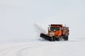 Snow plough clearing road in winter storm blizzard Royalty Free Stock Photo