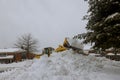 Snow plough truck clearing road after winter snowstorm for vehicle access Royalty Free Stock Photo