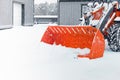 Snow plow doing snow removal during snowfall. Blizzard weather conditions. Winter time street maintenance. Close-up Royalty Free Stock Photo