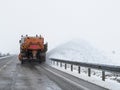 Snow plow machine working on the road