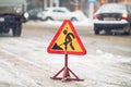 Snow-plow remove snow from the city street.Warning road sign.Winter service vehicle snow blower work.Cleaning snowy Royalty Free Stock Photo