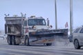 A Snow Plow with a Salt Spreader. Snow plow salting street in winter time. A truck deicing