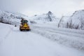 Snow plow truck clearing icy road after winter snowstorm blizzard for vehicle access Snow blower clears snow-covered streets