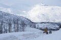 Snow plow truck clearing icy road after winter snowstorm blizzard for vehicle access Snow blower clears snow-covered streets Royalty Free Stock Photo