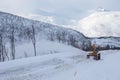 Snow plow truck clearing icy road after winter snowstorm blizzard for vehicle access Snow blower clears snow-covered streets