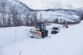 Snow plow truck clearing icy road after winter snowstorm blizzard for vehicle access Snow blower clears snow-covered streets Royalty Free Stock Photo