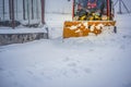 Snow plow truck clearing road after winter snowstorm blizzard for car. Royalty Free Stock Photo