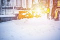 Snow plow truck clearing road after winter snowstorm blizzard for car. Royalty Free Stock Photo