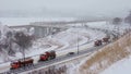 Snow plows drive on the highway and clear the road of snow after heavy snowfall, blizzard