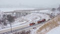 Snow plows drive on the highway and clear the road of snow after heavy snowfall, blizzard