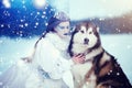 Snow queen in winter. Fairy tale girl with Malamute Royalty Free Stock Photo