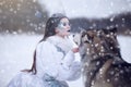 Snow queen in winter. Fairy tale girl with Malamute. Royalty Free Stock Photo