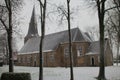 Snow on reformed church, trees and grass in Zevenhuizen, Netherlands