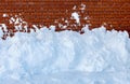 Snow removal  against a brick wall Royalty Free Stock Photo