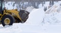 Snow removal with loader machinery after blizzard